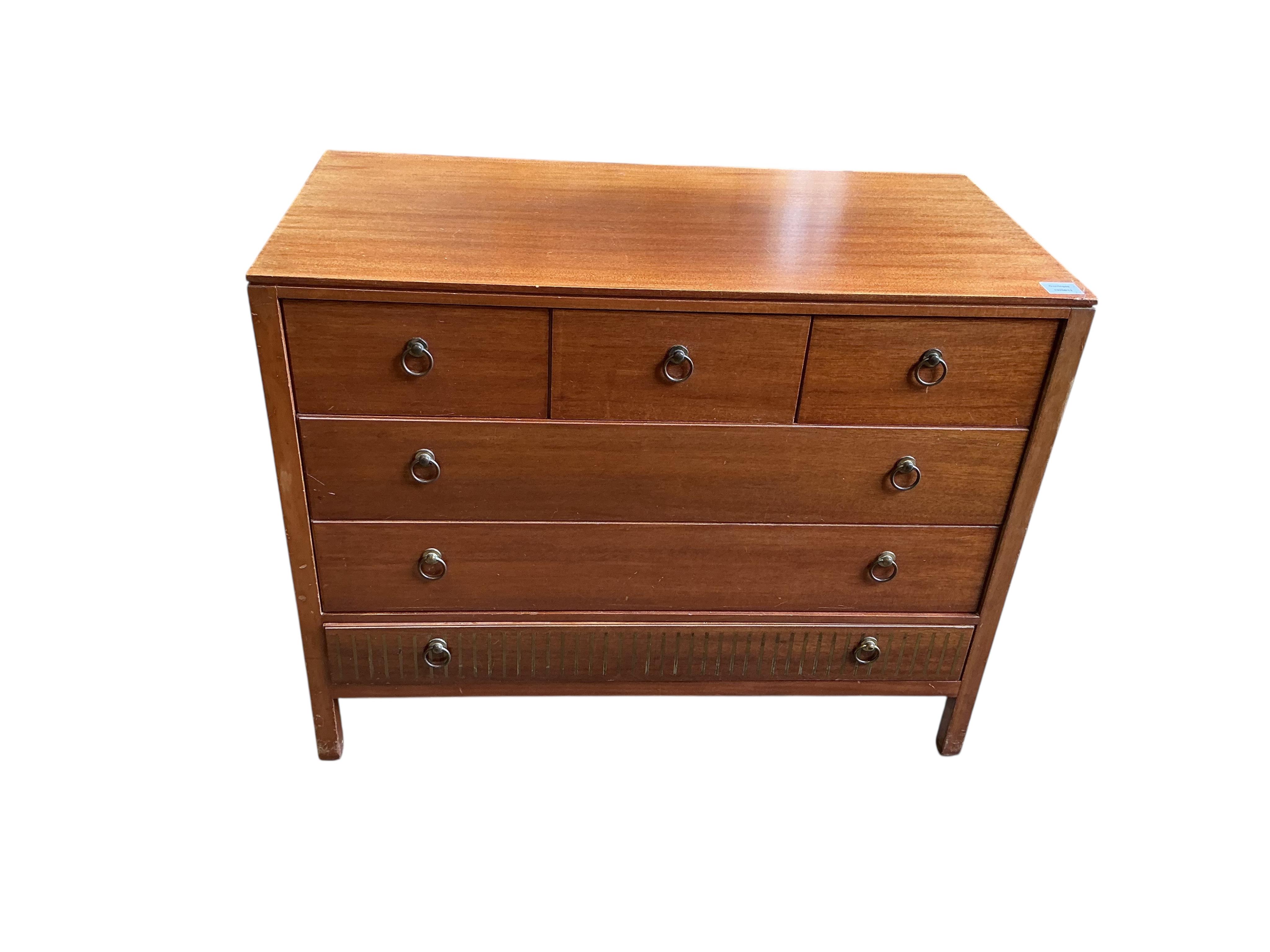 A Loughborough For Heals brass inlaid teak four piece bedroom suite comprising: triple wardrobe, width 120cm, depth 54cm, height 176cm, two chests of drawers and a toilet mirror